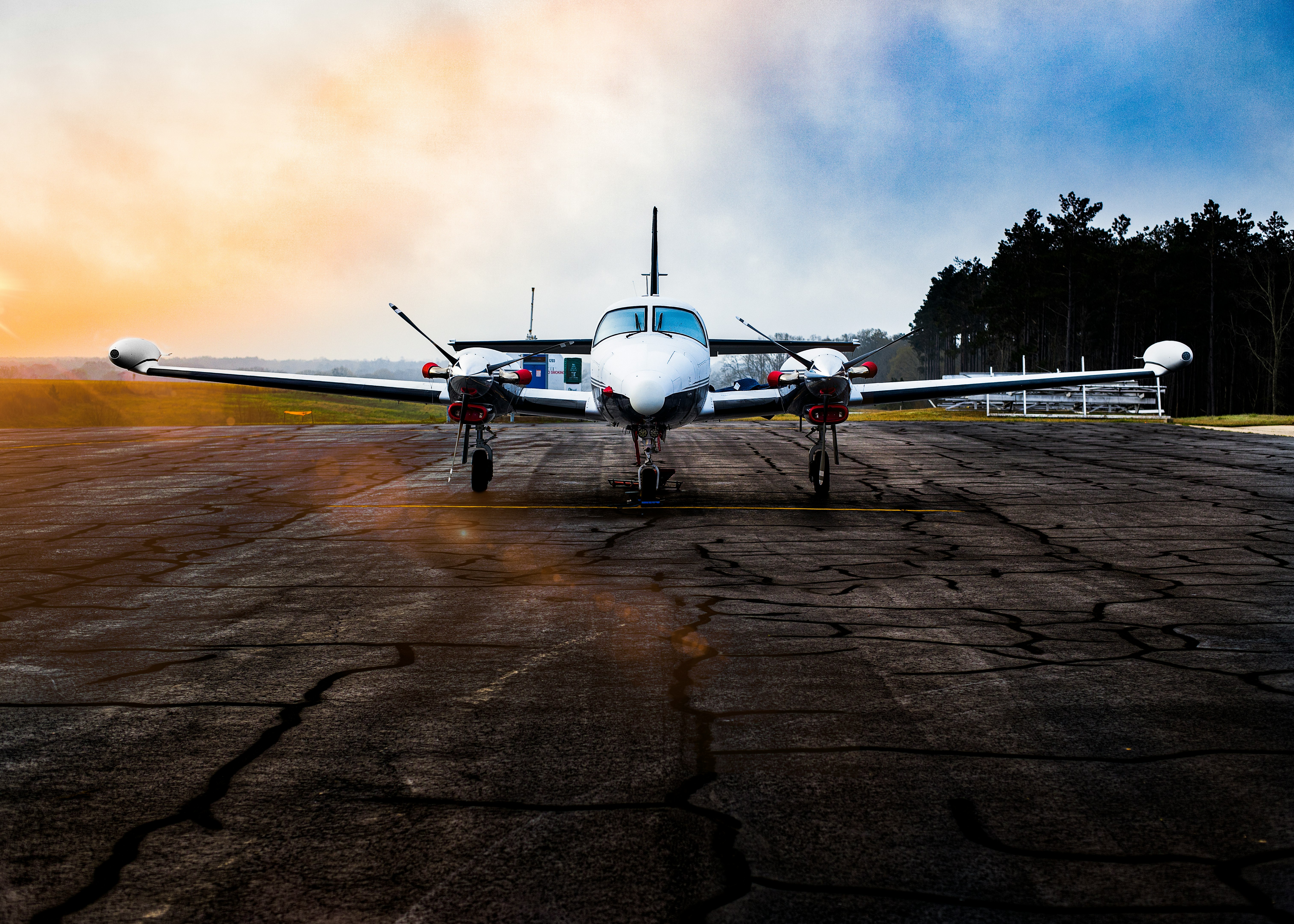 white airplane on brown field under gray clouds